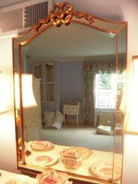 Bedroom #3-Upstairs:  The gold frame beveled mirror has an inner mirror frame and measures 26" wide x 40" tall.  Reflected in the mirror are several pieces of red and white transferware.