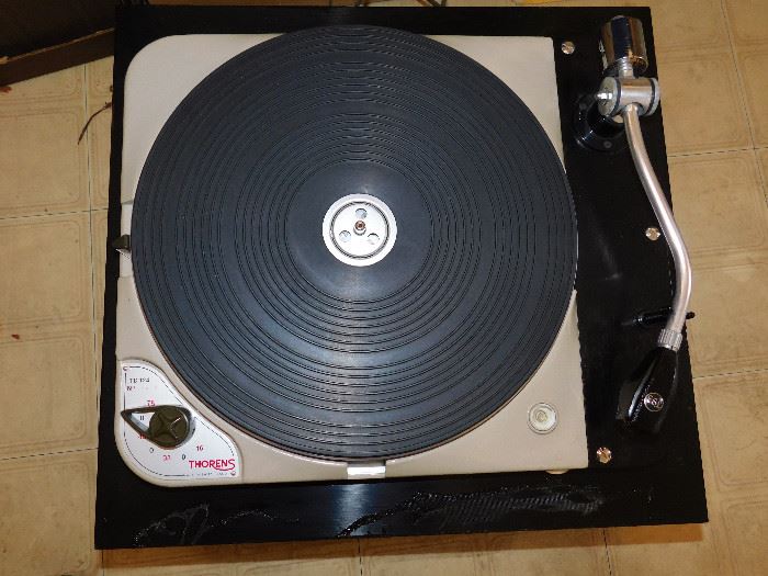Thorens TD124 turntable. The front of the box is not scratched, it has a bit of plastic stuck to it from the clear cover being over it.