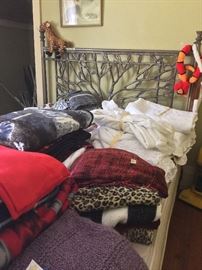 Very nice tree head board and bed. PLenty of linens as well. In addition lots of curtains