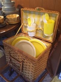 Vintage picnic basket with yellow dishes 
