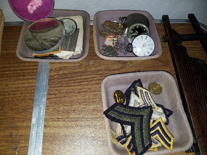 Variety of military patches and pocket watches