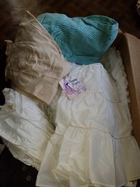 Variety of slips and petticoats for girls and woman. Some still with tags still on
