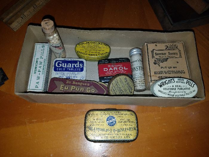 Great variety of antique pill tins and bottles