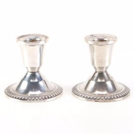 Vintage Duchin Creation Weighted Sterling Candle Holders: A pair of weighted sterling candle holders by Duchin Creation. These pieces features gadroon trim around the scone and base. The underside of each is stamped “Duchin Creation Sterling Weighted”. These pieces date to the 1950s.