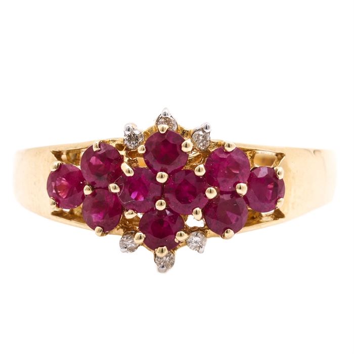 14K Yellow Gold Ruby and Diamond Ring: A 14K yellow gold ruby and diamond ring. This ring features ten rubies to the center with six round brilliant cut diamond accents to the top of the ring.