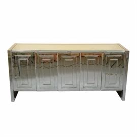 Ello Five-Door Mirrored Chrome Credenza: Ello Five-Door Mirrored Chrome Credenza. This piece features raised mirrored panels to each of the French hinged doors. The piece has five exterior doors with the four outer doors opening to reveal two drawers and shelves, with the middle door opening to reveal more of the same shelving. All parts of this piece are mirrored with the exception of the back section.