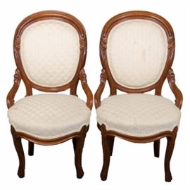 Pair of Vintage Balloon Back Chairs: A pair of vintage balloon back chairs with off white fabric. These two chairs have modified arms and cabriole legs. They each feature floral accent carvings to the back and arms. The fabric is an off white damask pattern.