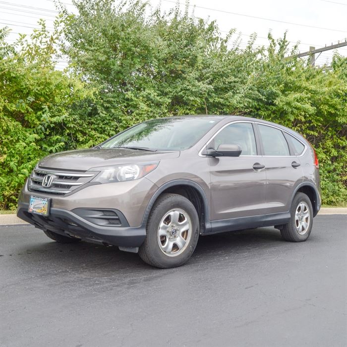 2012 Honda CRV LX: A 2012 Honda CRV LX with black interior. Odometer reads 86,255 miles. This Titanium color mid-size 4 door SUV features an i-Vtec 2.4 Liter DOHC four-cylinder engine and five-speed automatic transmission. It also has a black interior, air conditioning, alloy wheels, AM/FM CD stereo system, cruise control, power locks and windows, USB audio interface and rear wide-view camera. There is a dent on the front passenger-side bumper and smaller dent near the gas tank.