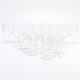 Clear Etched Stemmed Wine Glass: A clear etched stemmed wine glass. This collection of twenty five glasses includes eight red wine glasses, six coupe glasses, and eight white wine glasses. They are etched with a floral motif.