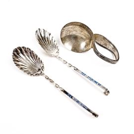 Sterling Silver Spoons: A collection of sterling silver spoons. There are two spoons with shell shaped scoops marked “Haimond Sterling” and marked on the front of the handle in blue “Peo-Sterling ’62”. Also included is a finger spoon with a bent handle and large round scoop marked “Sterling”.