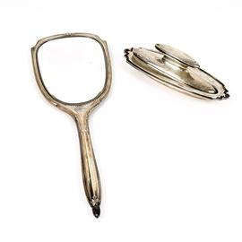 Sterling Silver Mirror and Nail Buffer: A sterling silver mirror and nail buffer. Featured here are two sterling silver vanity items including a hand mirror and nail buffer. The mirror is marked “Sterling 7702”. The nail buffer is marked on its side and base “Alvin Sterling”.