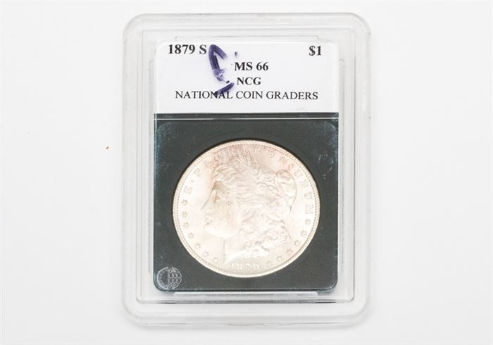 1879-S Morgan Silver Dollar: An 1879-S Morgan silver dollar. The coin features a left facing profile of Lady Liberty on the obverse. The reverse depicts a bald eagle clutching an olive branch in one talon and a bundle of arrows in the other, surrounded by the text “United States of America", “One Dollar”, and “In God We Trust". Designer: George T. Morgan. Mintage: 9,110,000. Metal Content: 90% silver, 10% Copper. Approximate diameter: 38.1 mm. Approximate weight: 26.73 grams. Condition: Very good – circulated. Please preview for your own personal assessment.