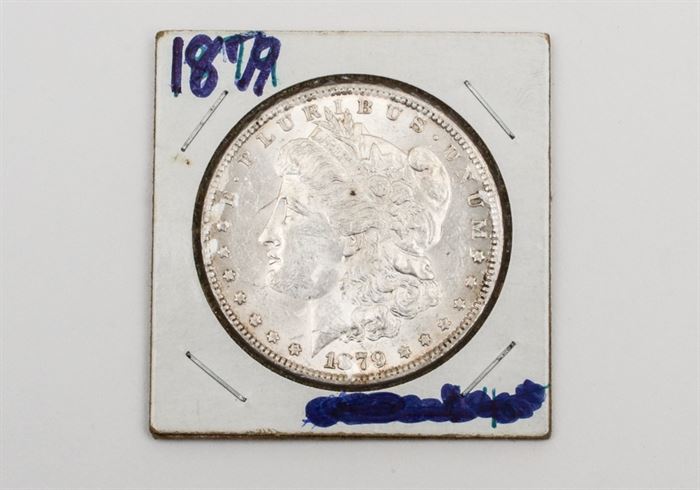 1879 Morgan Silver Dollar: An 1879 silver Morgan dollar. Designer: George T. Morgan. Mintage: 14,806,000. Metal content: 90% silver, 10% copper. Diameter: 38.1 mm. Weight: 26.7 grams. Circulated. Very good condition.