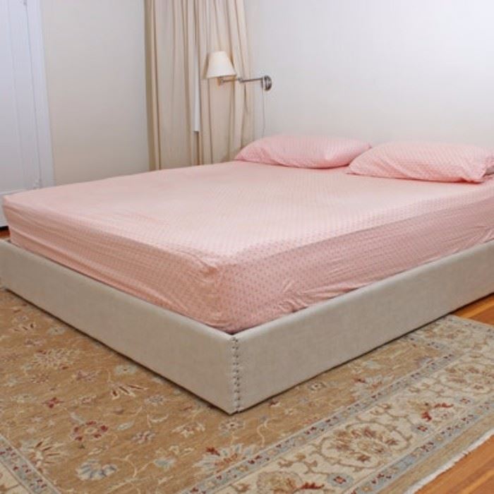 Linen Upholstered King Sized Platform Bed: A linen upholstered king sized platform bed. This platform bed frame features nailhead trim to each joint. Included with the frame are slats.