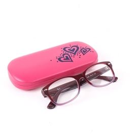 Ray-Ban Glasses: A pair of Ray-Ban eye glasses featuring two-tone red frames. The frames are marked “RB 1528 3583 38-16 130” to the interior of the arms and “Ray-Ban” along the side. Includes a pink case with hearts.