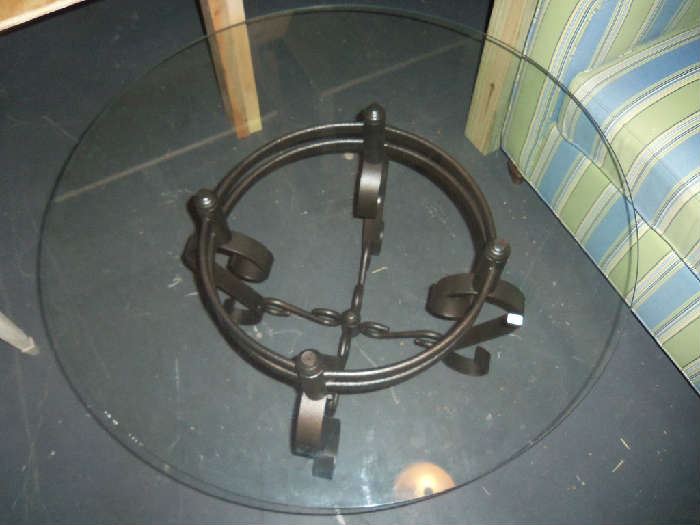 Glass top round coffee table with bronze base.
