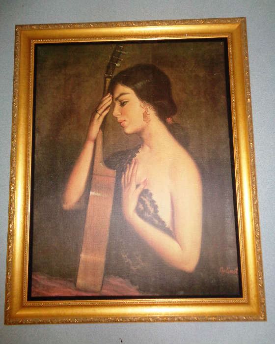 Unique oil of a senorita with her guitar.  Beautiful wooden frame with carved border and finished in gold.