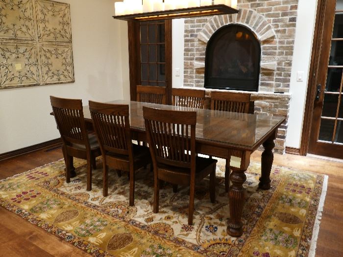 Hand built solid oak dining table with (8) matching solid oak chairs. (2) not shown in photo but will be there with the others at sale) Custom cut glass top to protect the finish. 2 extra leafs. Beautiful