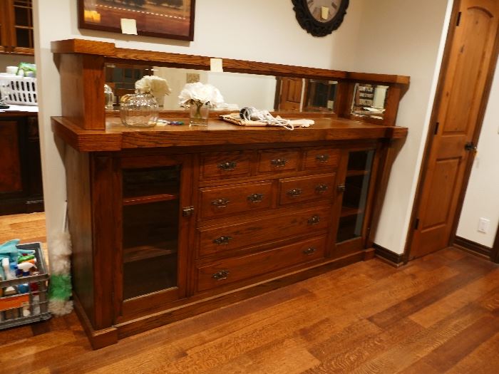Antique solid oak breakfront, buffet. Professionally restored piece taken from Mansion in Milwaukee. We built this wall to fit this piece exactly. Looks like a built in. Has a beveled mirror and glass cabinet doors. Photo does not do this piece justice. 