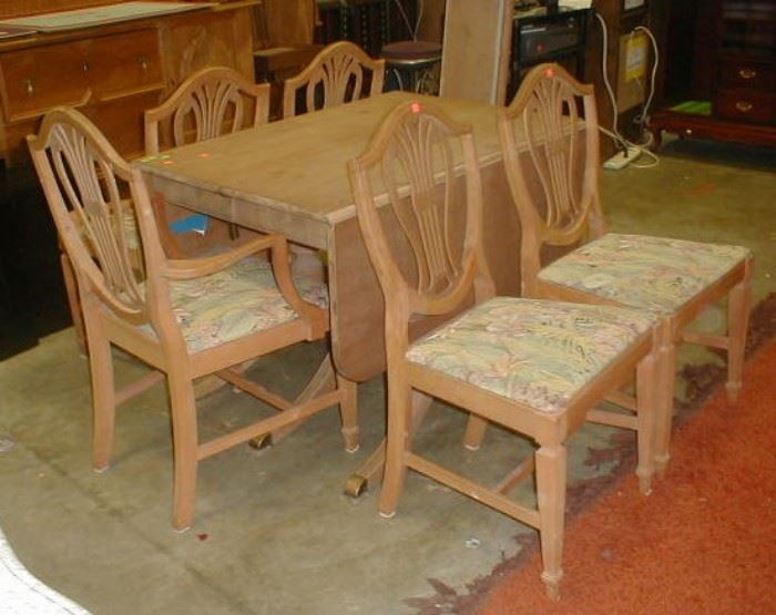 1940's drop leaf dining table and five chairs, finish has been striped. $45.00
