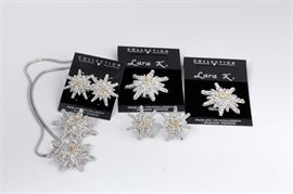 Collection of Lara K Jewelry with Swarovski Elements: A collection of Lara K. jewelry with Swarovski elements. This collection includes two necklaces with starburst pendants, two additional pendants, and two pairs of earrings. They are decorated with crystal rhinestones by Swarovski.