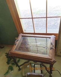 Vintage tray end-table: carved “Indian” covered in glass.