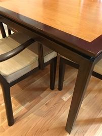 Stunning and in beautiful condition: Classic Dunbar dining table. All original two-tone finish. The table starts at 66 inches wide and has two 24" leaves extending the table to a nine and one half feet.