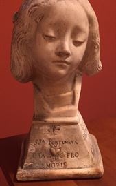 Stone (plaster?) head of a woman ("Ora pro nobis," pray for us) is Mexican, c. 1950.
