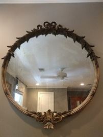 Vintage 29" diameter carved wood/gilt mirror.