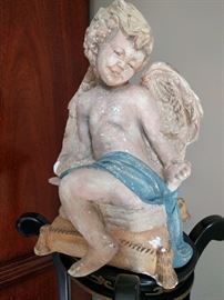 Vintage chalk figure of an angel admiring her new engagement ring. He must have gone to Jared's...