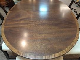 Vintage banded mahogany Kittinger dining room table, with two leaves and six chairs, 2 side, 4 arm.