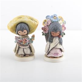 Goebel "The Children of DeGrazia" Porcelain Figurines: A pair of porcelain figurines from The Children of DeGrazia Collection by Goebel. This selection includes two figurines after paintings of Ettore “Ted” Degrazia. It features Flower Boy (10311) and Flower Girl (10310). Each is debossed to the base with the DeGrazia signature and the underside is stamped “©Goebel W. Germany” and debossed with the year 1983.