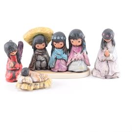 Goebel DeGrazia Porcelain Nativity Figures: A collection of Goebel nativity figures. This collection of four pieces includes a baby Jesus, an angel, a three person figure, and a person in a white gown. These pieces are designed by Ted De Grazia and are labeled The Nativity and We Three.