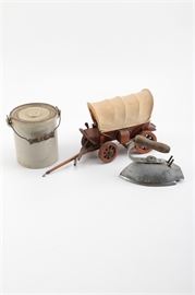 Vintage Iron, Jar, and Miniature Carriage: A selection of vintage decor. There is a jar with a lid and handle and a vintage iron, both with a wooden handle. The carriage is carved wood with a canvas style top and has multiple applied accents around the exterior.