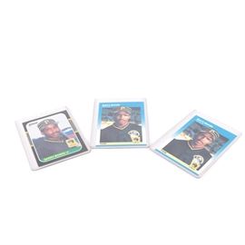 Barry Bonds Trading Cards: A grouping of baseball cards. This assortment contains three cards that feature the renown baseball player Barry Bonds. The cards are held in protective plastic sleeves.