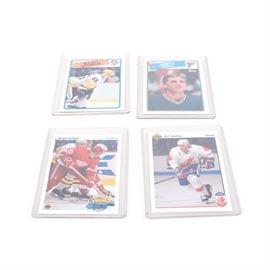 Mario Lemieux Hockey Trading Cards: A grouping of hockey trading cards. This grouping contains four different cards of renown professional hockey player Mario Lemieux from different points in his career. The cards are held in protective plastic sleeves.