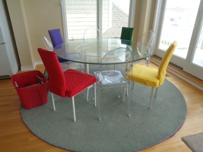 Unique glass top table w/clear acrylic chairs (w/covers).  Also round area rug.