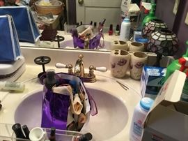 Bathroom full of cosmetics, lotions, trays, and lots more.