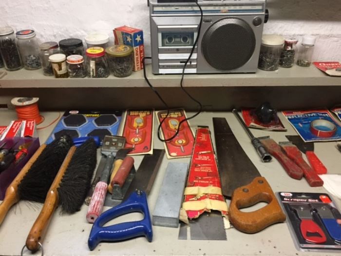 Many tools, saws, jars of screws and nails