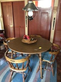 4 chairs with matching table plus two leaves.  In background is painted cupboard/wardrobe.Early forged hinges.  Lamp remains with house..