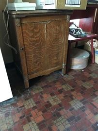 Nice tiger oak cabinet with original sewing machine.  Think about repurposing as a liquor cabinet?  