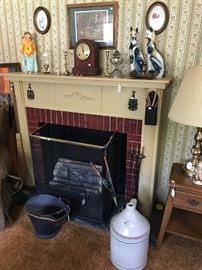 One, of two removable firplaces.  Early coal bucket with stenciling.  Unusual chalk ware pair of cats.  Clock, not working.  Trivets (more also in house), fireplace implements and screen.  Electric lighted logs.  4 gallon blue decorated jug .