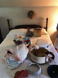 Double size bed in Mahogany with pineapple design posts.  Vintage Hats and composition doll in cradle..