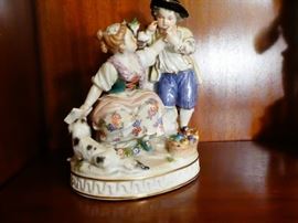 Meissen figurine depicting a girl sitting on a rock with a boy next to her on bended knee German 19th century hard-paste porcelain polychrome detail. 6 1/2 inches high 