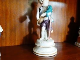 Late 19th century Meissen figurine depicting a sad faced "Little beggar Boy" who appears to be an orphan with a wooden legWooden leg is a shill and his real leg is bent behind him  hard-paste porcelain with polychrome detail