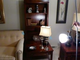 unique coffee table with bookshelf  silver candlesticks, leaded crystal bowls and antique books.