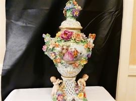 Dresden porcelain urn  German mid 20th century elaborately decorated with high relief fruit and flowers in polychrome with central reserver painted with a  pair of courtiers in the landscape