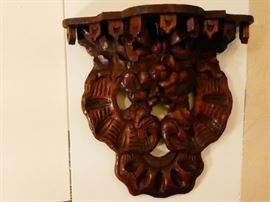 heavily carved wooden shelf 
