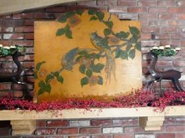 wood carved fire place covering and two candle holding reindeer.