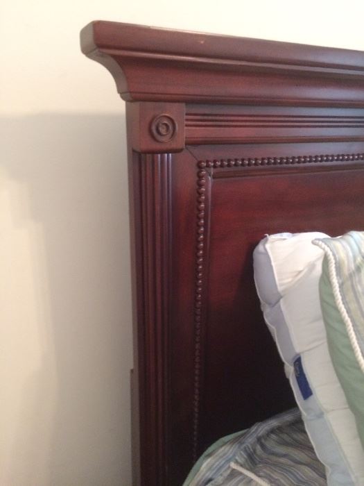 close up of detailing on cherry finish headboard 